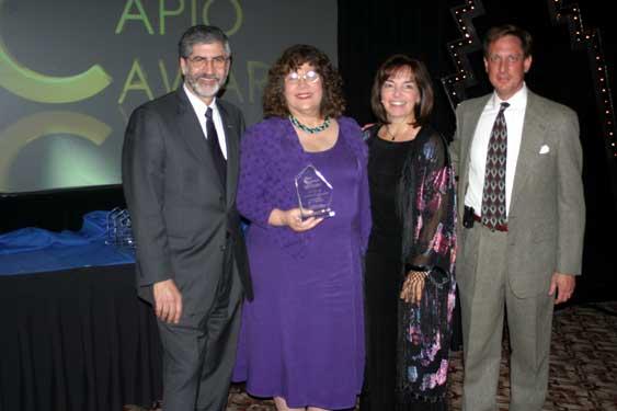 Longtime CAPIO members Judy Rambeau, Scott Summerfield and Tom Manheim, all past Clark Award winners, presented a plaque of achievement to Ann Erdman (with plaque) during the 2004 Conference and Awards Ceremony in Monterey.