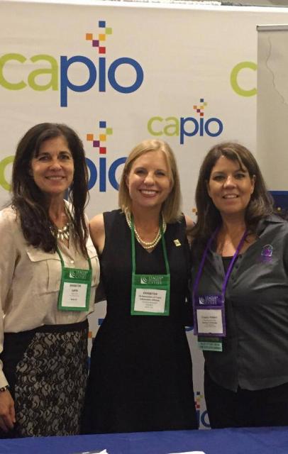 Three women in front of a CAPIO backdrop